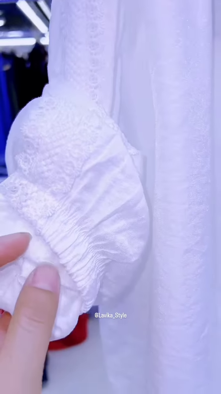 Elegant White Layered Outfit with Striking Blue Necklace - Image 5