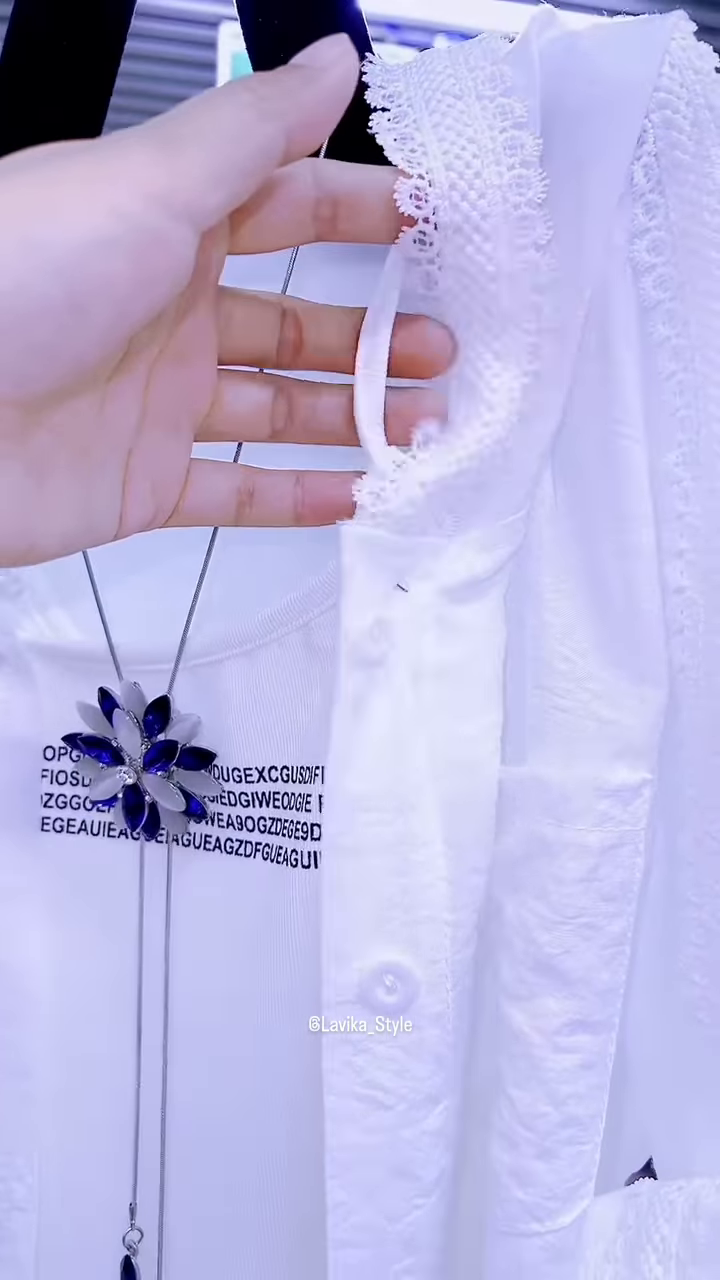 Elegant White Layered Outfit with Striking Blue Necklace - Image 2