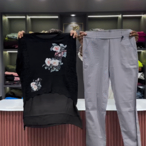 Black Open-Knit Top with Floral Appliqués and Gray Pants